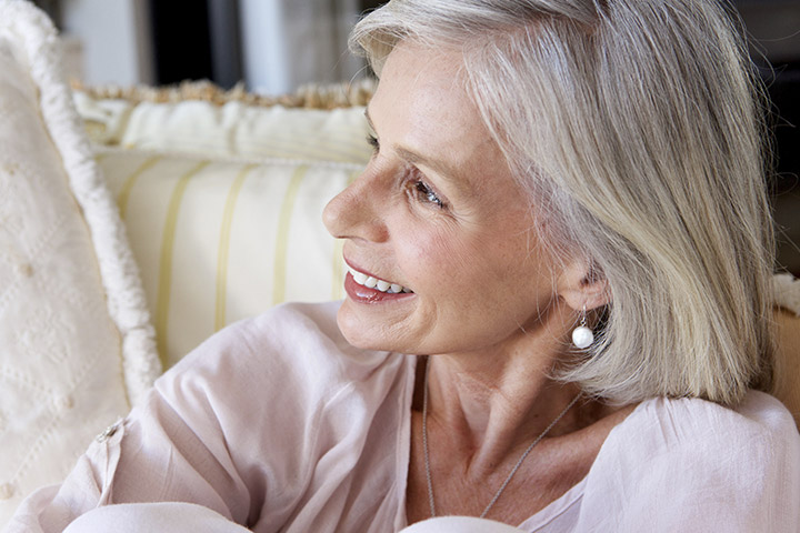 Confident mature woman showing smooth, refreshed skin after skin resurfacing in Gulf Shores.