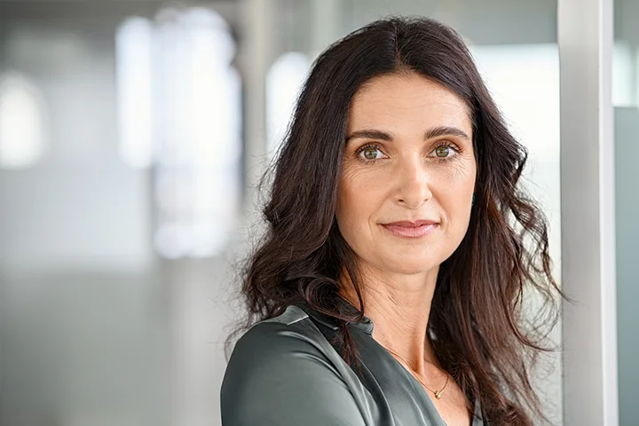 Confident woman with natural facial appearance, representing results patients seek when choosing Dr. Fedok for plastic surgery in Fairhope