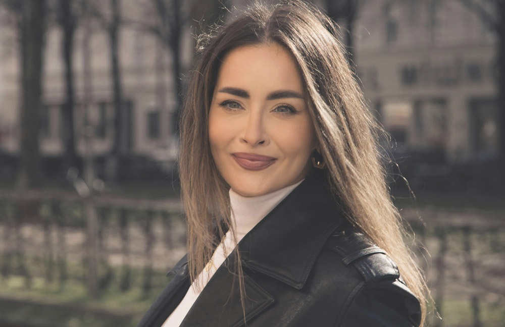 HydraLift Fusion: Woman smiling outdoors with radiant, smooth skin