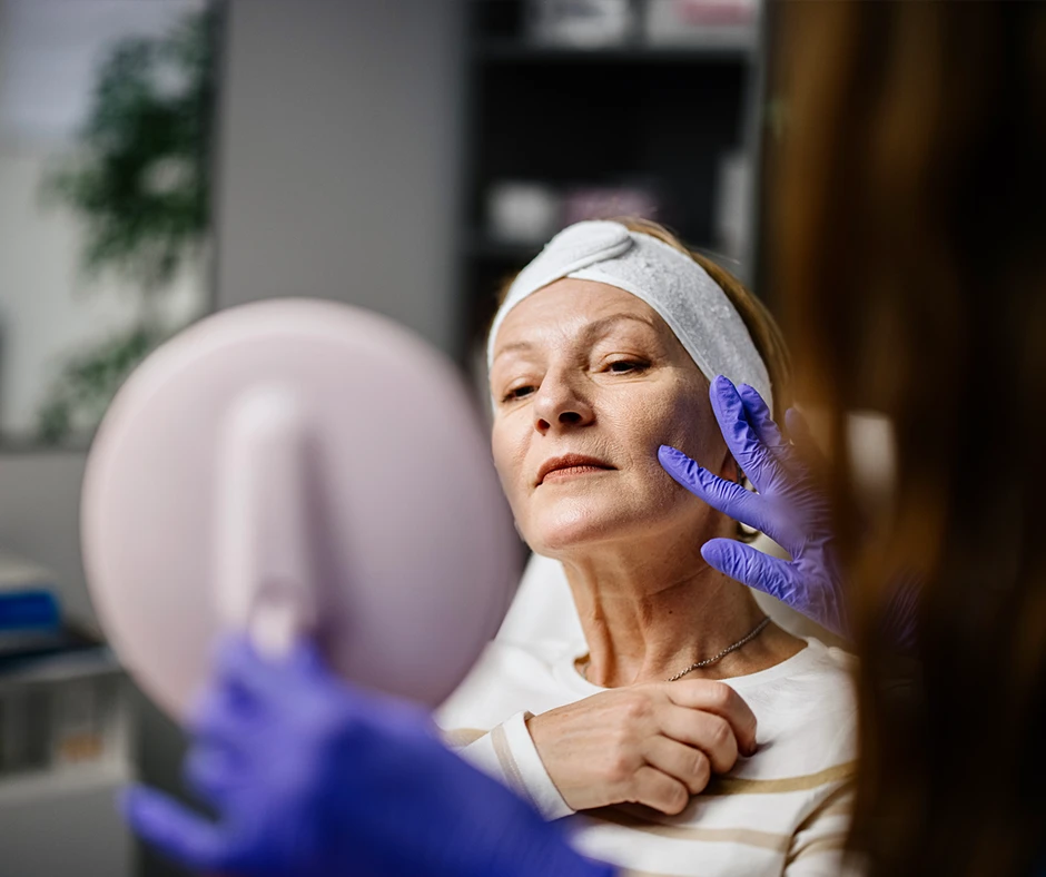 Woman receiving a facial examination during facelift recovery, illustrating expert guidance on how to speed up facelift recovery.